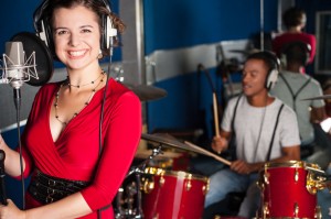 Female singer recording a track in studio